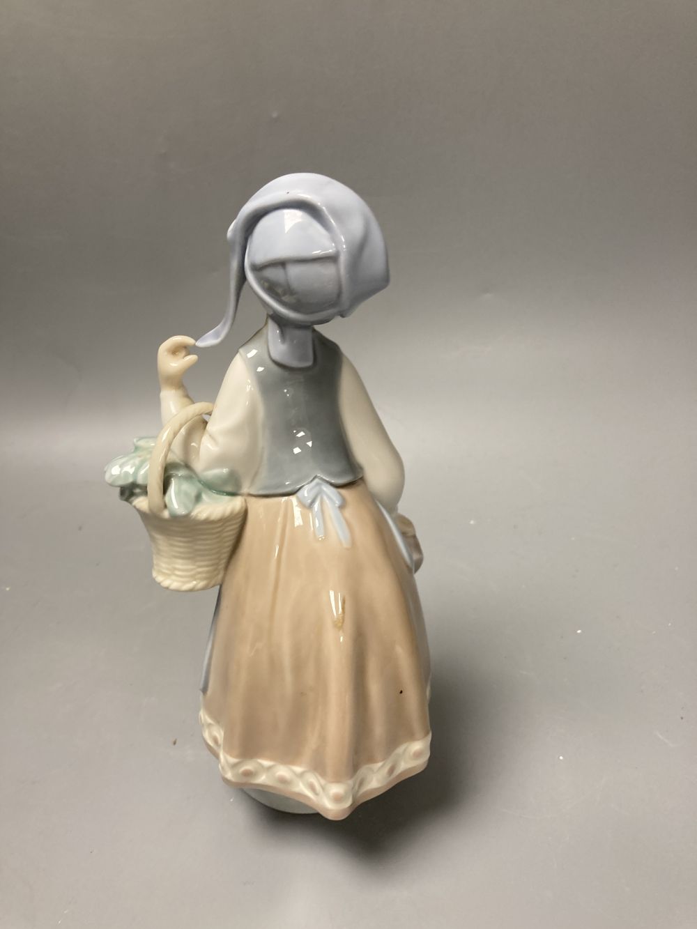 Two Lladro porcelain figures and a Royal Copenhagen model of a seal, tallest 26cm